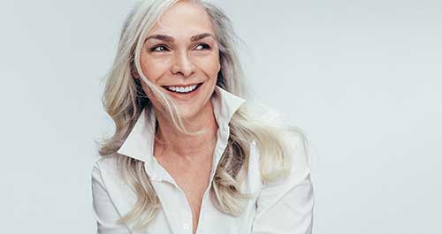 mid age woman smiling after getting a retirement annuity